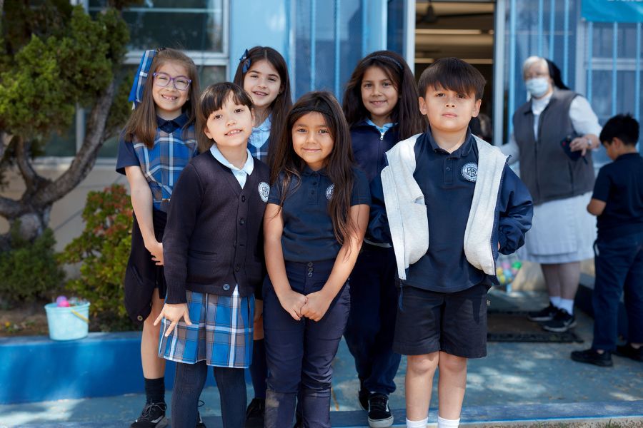 group of elementary school students wearing Catholic school uniforms