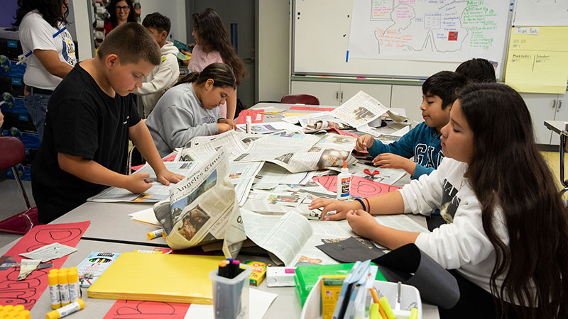 elementary-aged students working together at a table