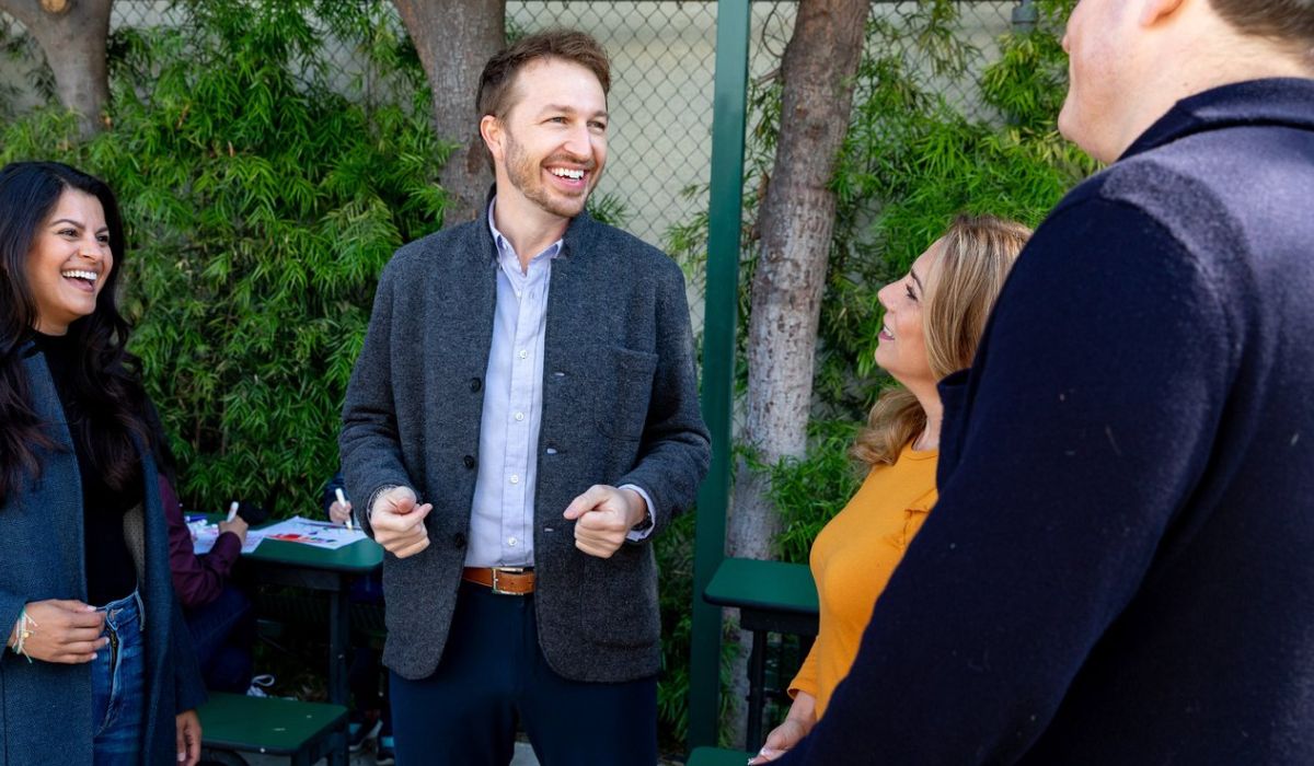 Photo of a man talking to a small group of people