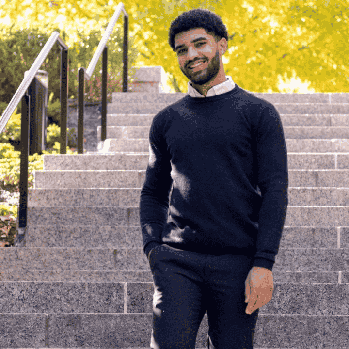 man standing on stairs in front of a tree
