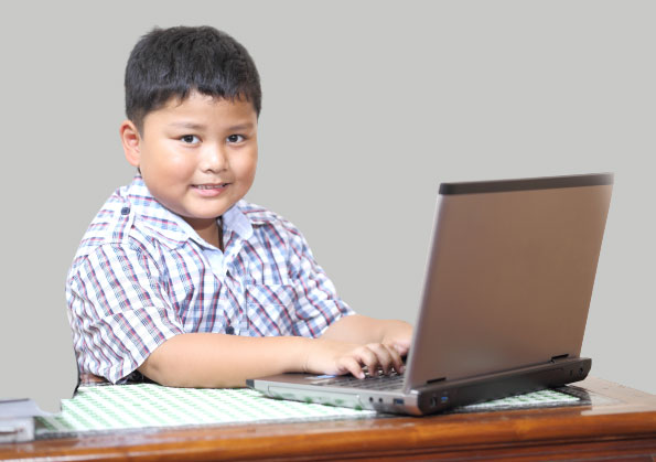 An elementary student using a laptop
