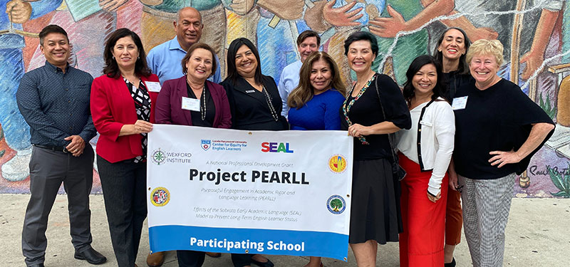 Project Pearll Leadership Team holding a banner