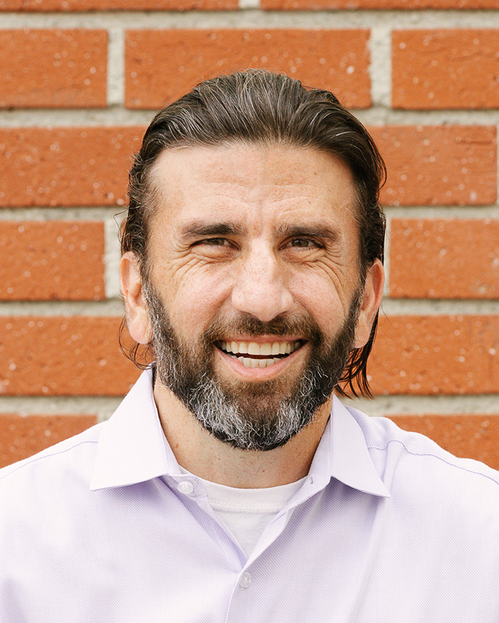 Drew Furedi Portrait in front of a brick wall