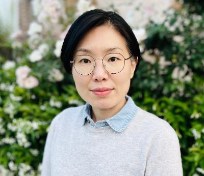 woman wearing glasses and a gray sweater