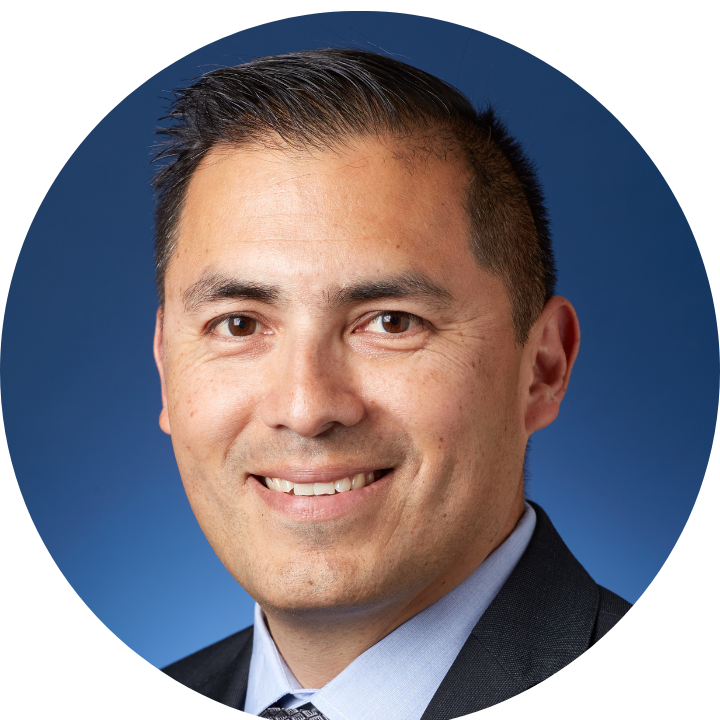 headshot of a man on a blue background