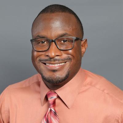 headshot of a man on a gray background