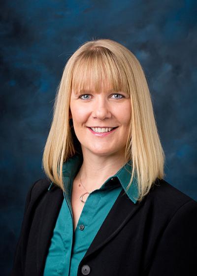 headshot of a woman on a blue background