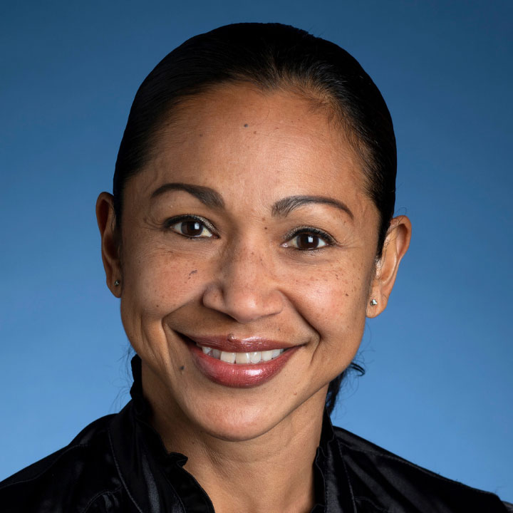 headshot of a woman on a blue background
