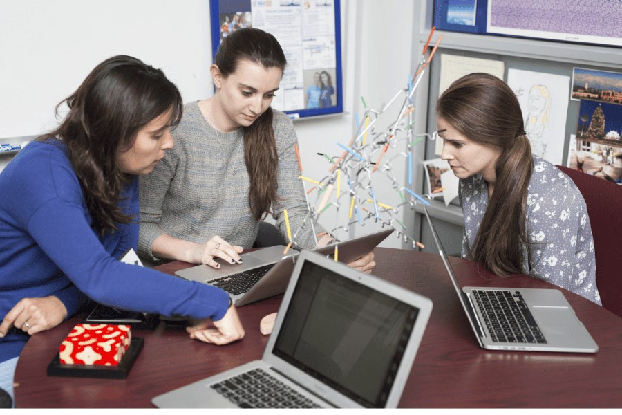 female college students working on their laptops