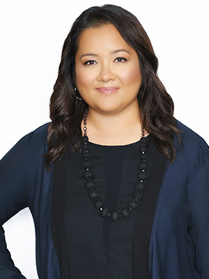 Woman in Blue and Black posing in front of white background