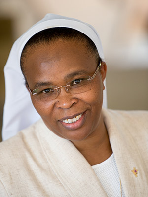 Jane Wakahiu Portrait in White Nun Habit and cream blazer