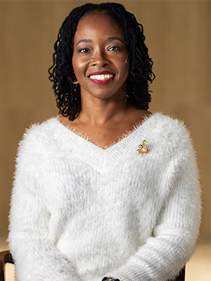 Laura Robinson Mcgowan Portrait woman with curly hair in white fuzzy sweater