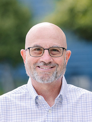 Matt Wunder Man in glasses wearing pattern shirt standing outside