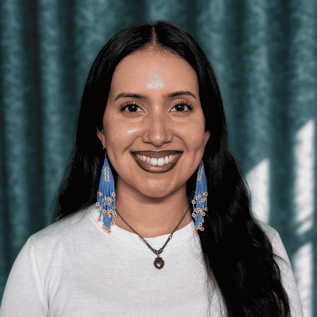 headshot of a woman wearing colorful earrring