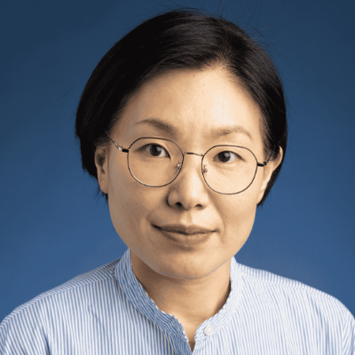 woman wearing glasses on a blue background