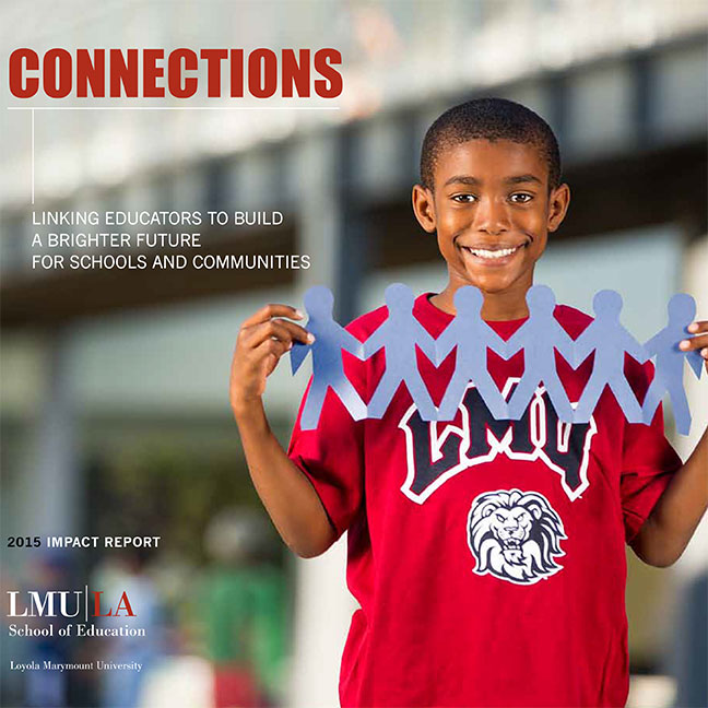 A student wearing an LMU branded shirt holding up a cut out piece of paper of several figures holding hands with the title Connections