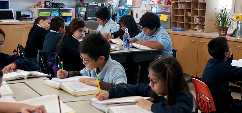 students working at desks in Catholic elementary school classroom