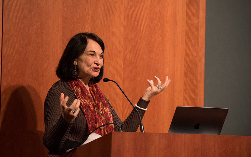 LMU SOE professor Antonia Darder lecturing and gesturing at a podium